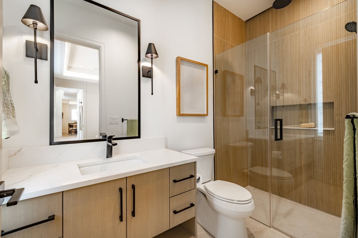Master bathroom with white marble floors and modern fixtures