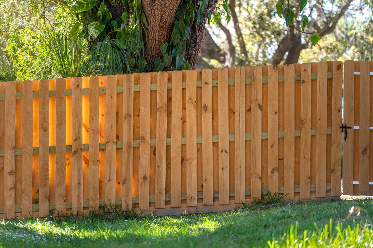 Completed wood privacy fence in residential backyard