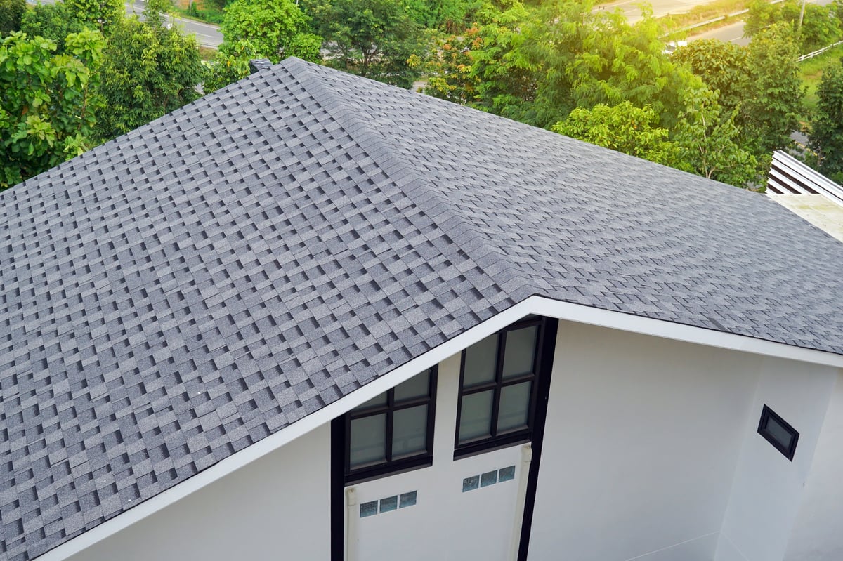 Completed asphalt shingle roof on modern residential home